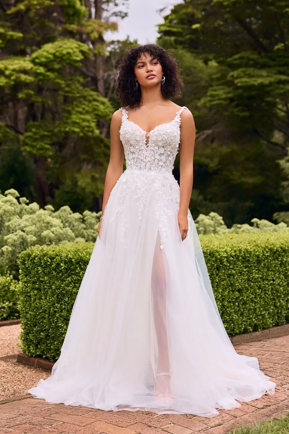 Daphne is a floral tulle A-Line dress with a sweetheart neckline and delicate lace straps. She has a glitter tulle skirt, optional hidden leg slit and is perfect for the bride wanting a romantic boho look.
