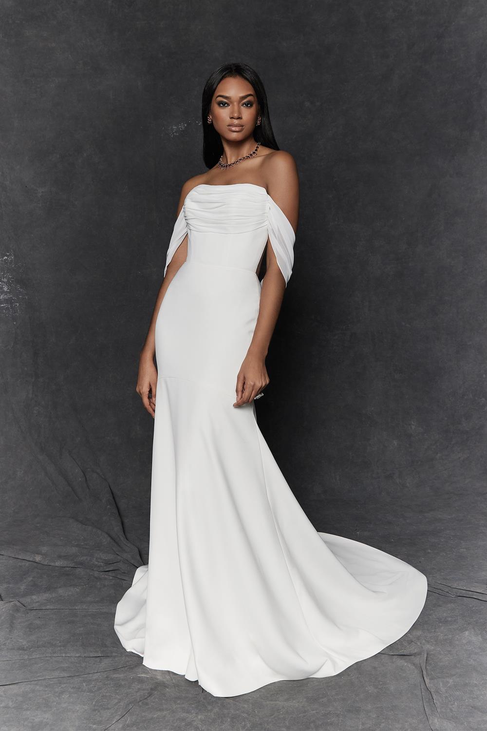 Limone is a a crepe fit and flare with a straight neckline and illusion back with exposed boning. She has beautiful ruching on the bodice with detachable chiffon streamers that create and off the shoulder straps and a self tie bow at the back leading to a chapel length train
